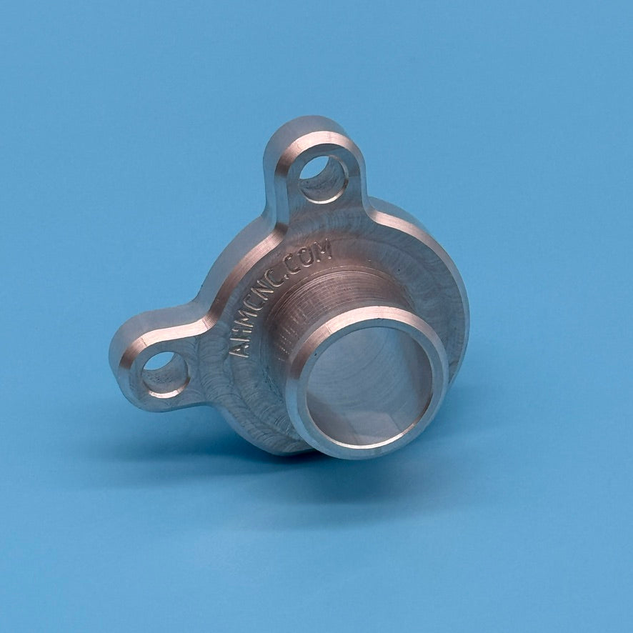 Bare aluminum CNC coolant hose flange for BMW (11-53-7-541-992), two bolt tabs and center hose port, engraved AHMCNC.COM.