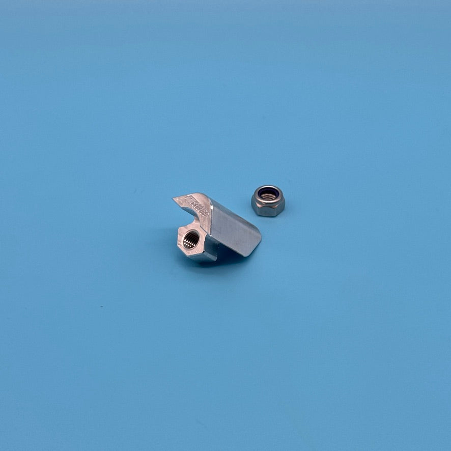 Bare aluminum Thule T2 locking wedge, top angle showing threaded bolt hole and hook, with lock nut.