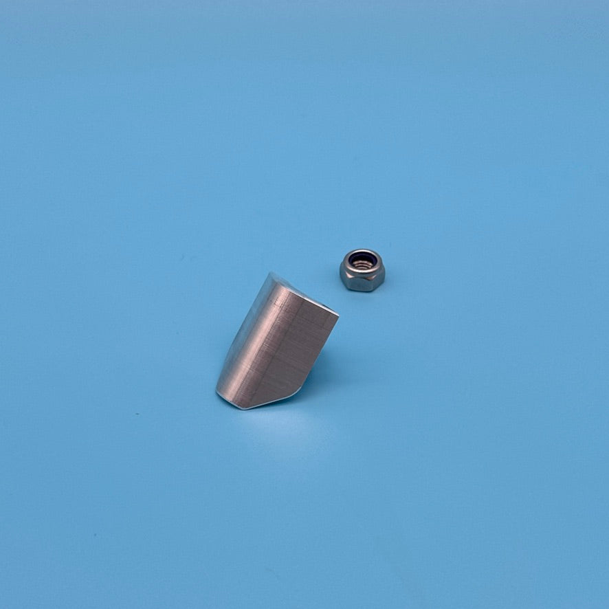 Raw aluminum CNC Thule T2 locking wedge from the rear, machined back face, with hex lock nut.
