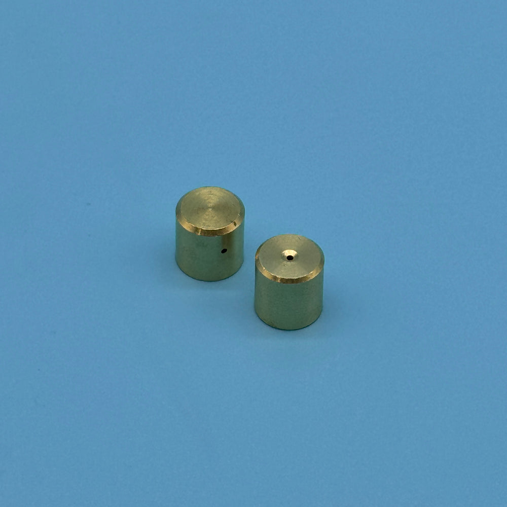 Pair of brass spray nozzle caps with a small center orifice for the Audi carbon cleaning kit.