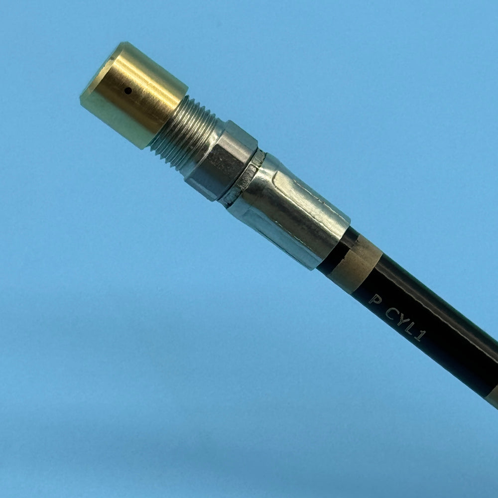 Hose end detail with brass spray tip and knurled collar, marked P CYL1 for the Audi secondary air port.