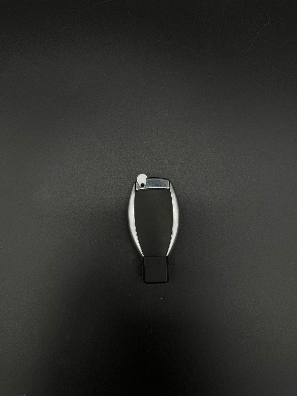 Back of a Mercedes-Benz smart keyfob with a white GEN-2 emergency key blade blank (PN MBZ002) seated.
