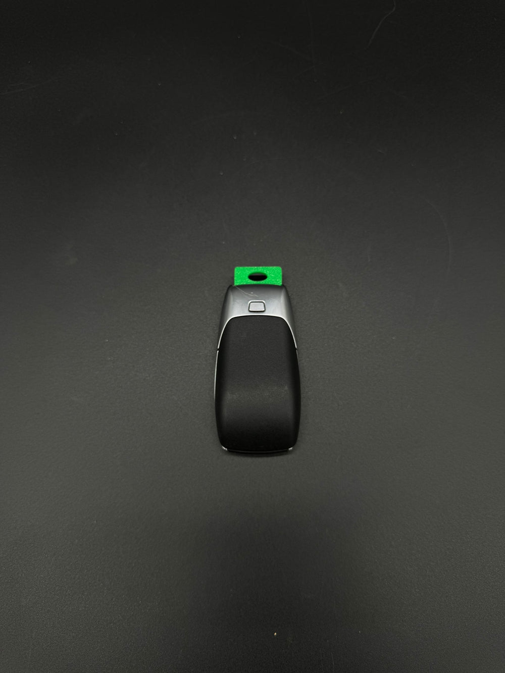 Back of a newer-style Mercedes-Benz smart keyfob with a green GEN-3 emergency blade blank seated.