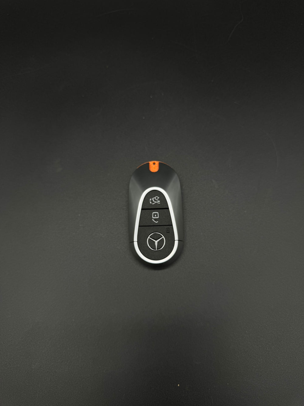 GEN 4 Mercedes-Benz smart key fob, front view - three buttons, star logo and orange top accent.