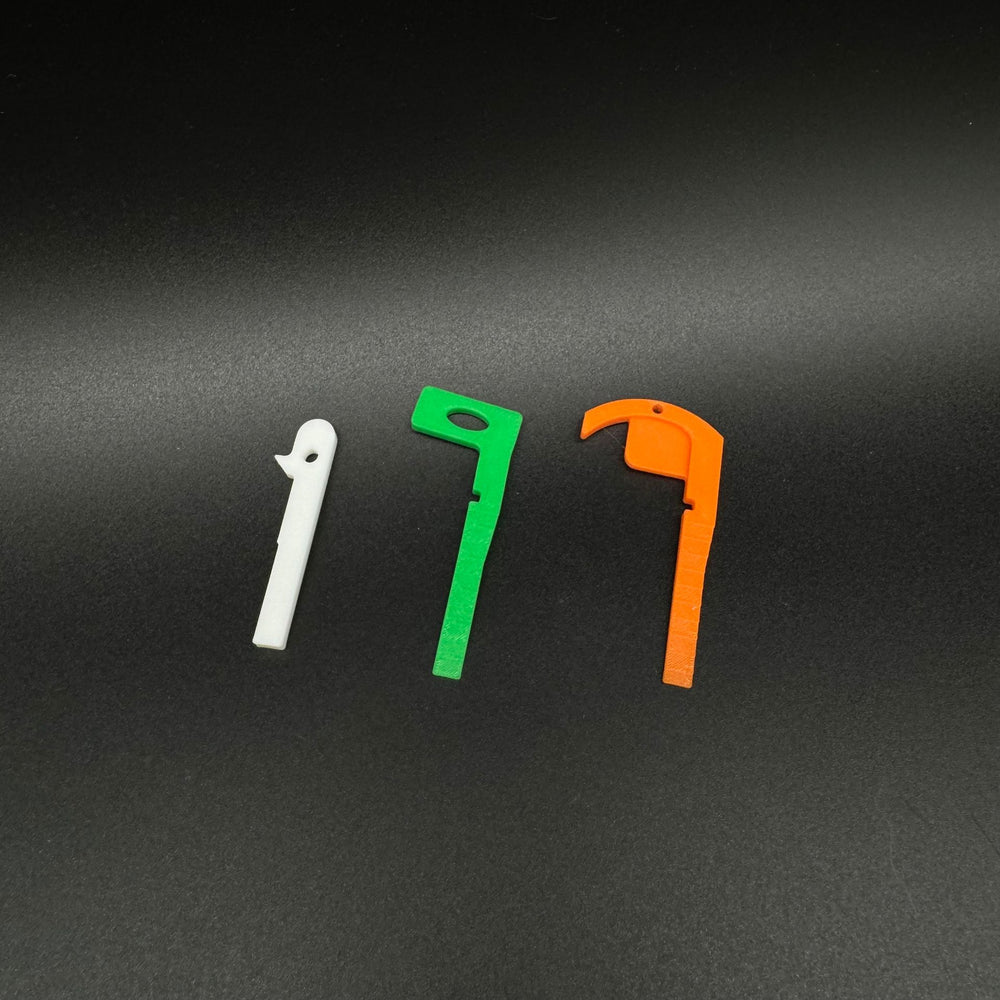 Three Mercedes key blank shapes side by side in white, green and orange for fob fitment comparison.