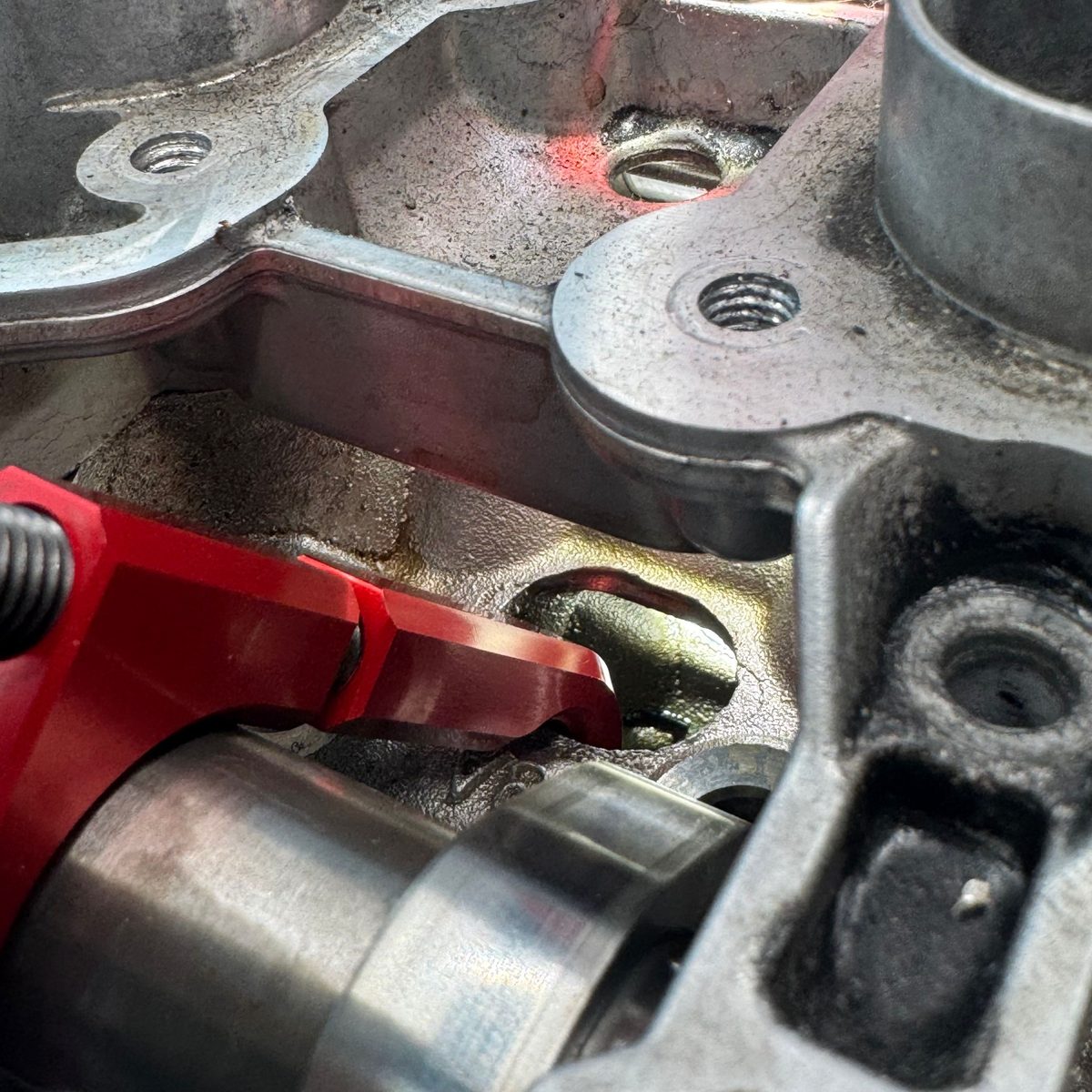 Sliding the moving hook onto the intake camshaft and threading the locknut